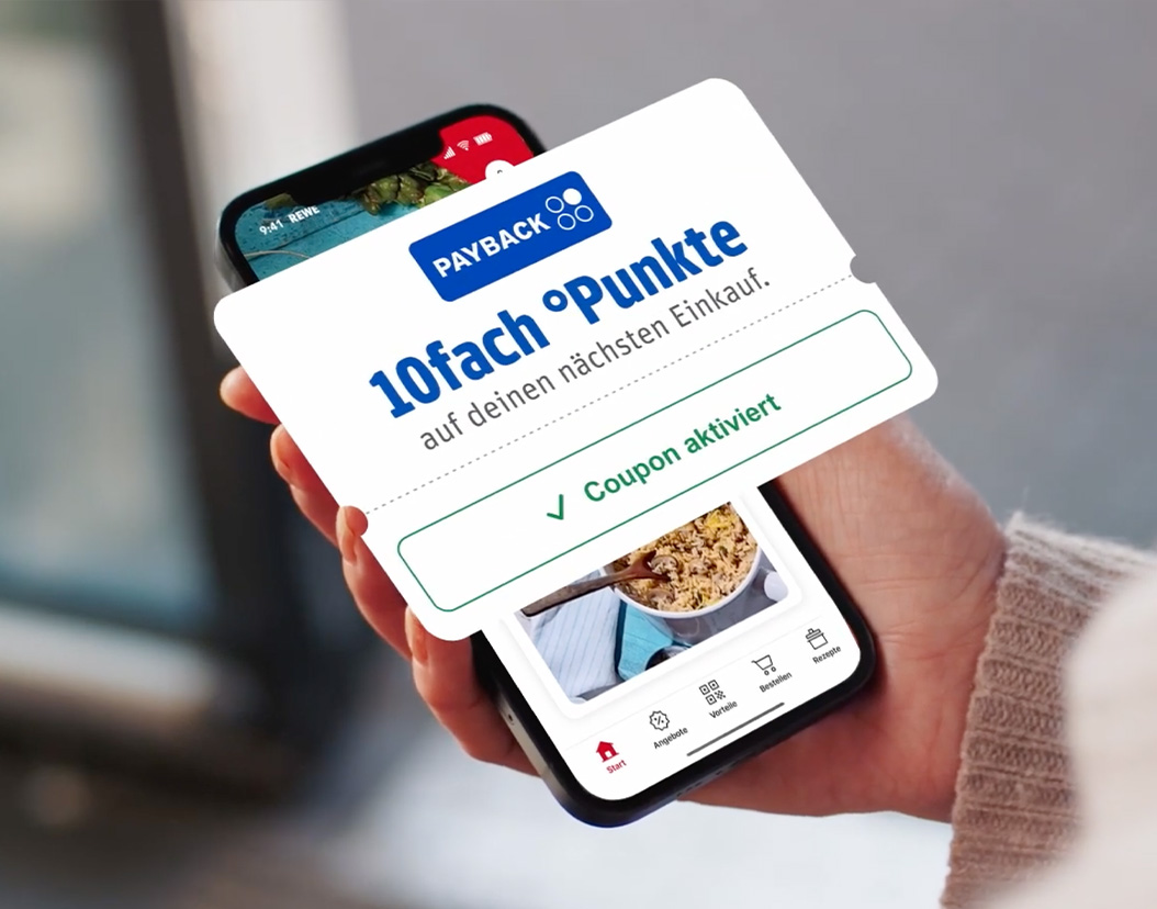 A smartphone displaying the REWE app with floating coupons